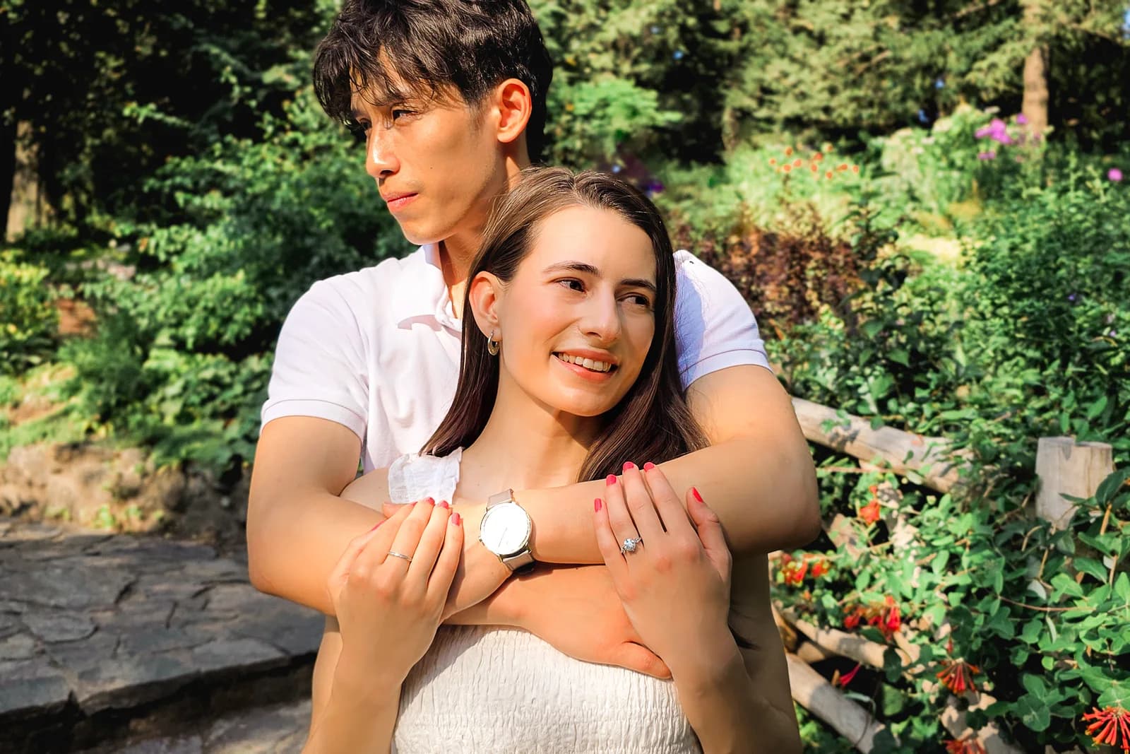 The couple smiling together outside