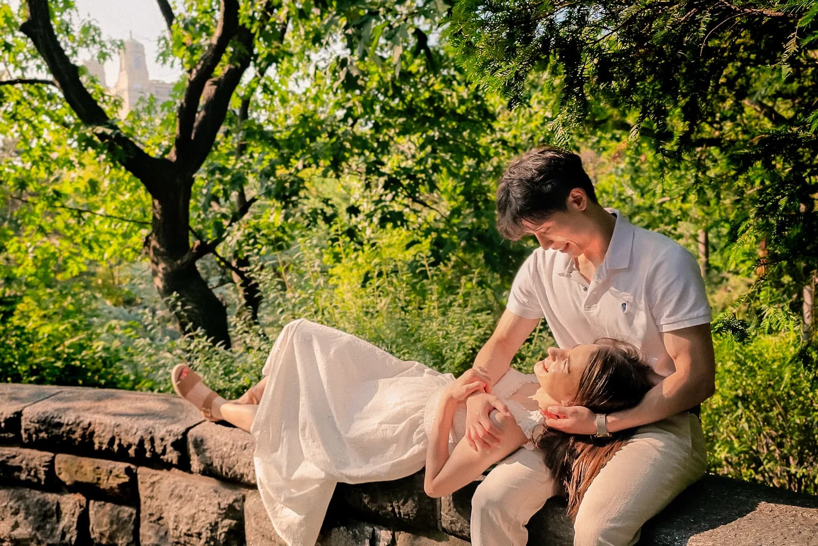 The couple standing together in a sunny outdoor setting