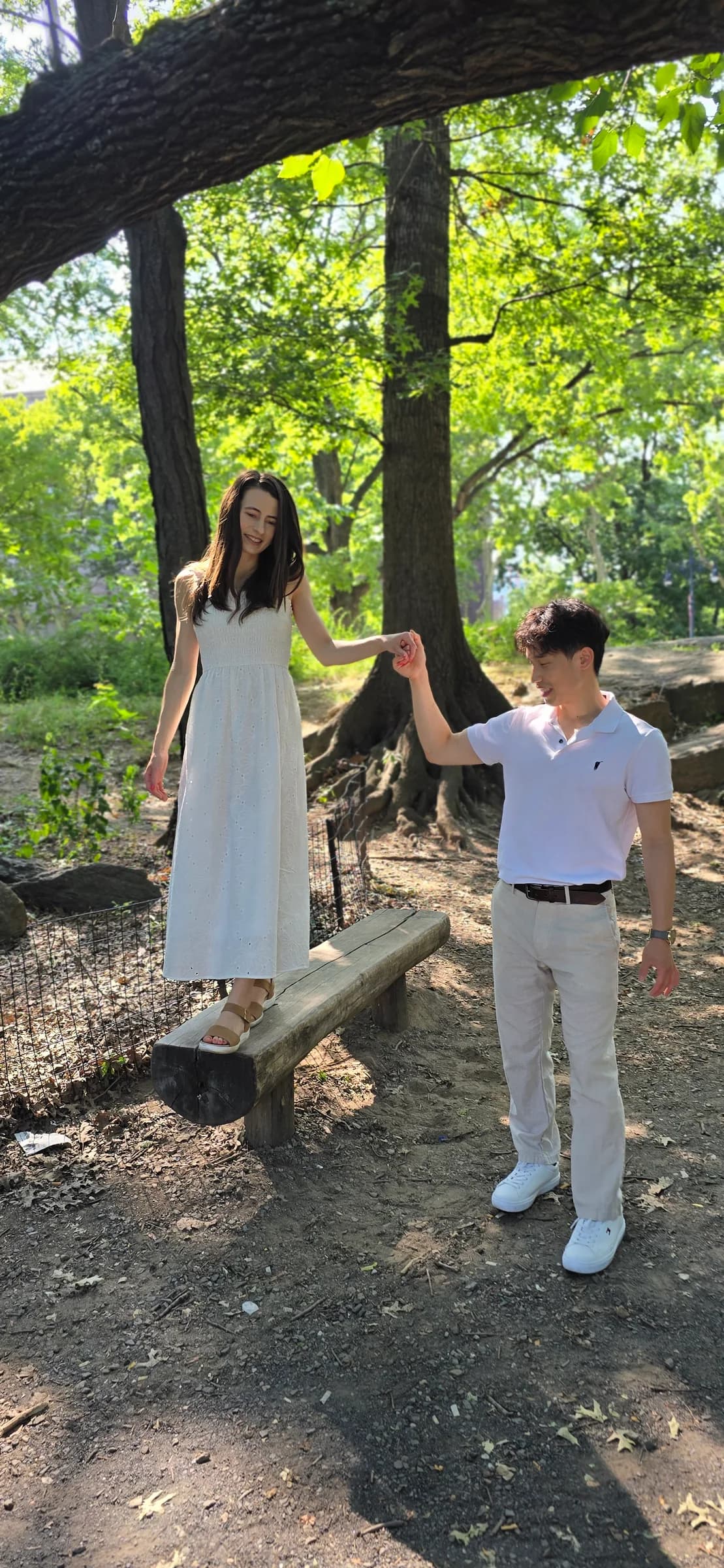 The couple captured in a vertical outdoor portrait